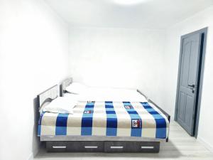 a bed in a white room with an open door at Meymandos in Tossor
