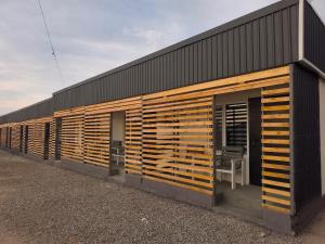 a building with wooden shutters on the side of it at Meymandos in Tossor