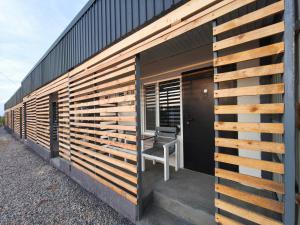 a building with wooden panels on the side of it at Meymandos in Tossor