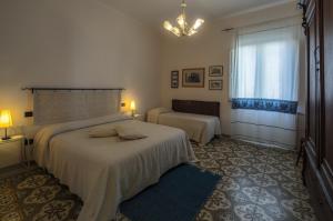 a bedroom with a large bed and a window at S'Attobiu Guest Rooms in Teulada +18 photos