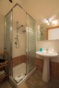 a bathroom with a shower and a sink at S'Attobiu Guest Rooms in Teulada