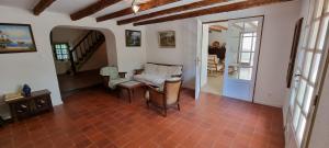 a living room with a table and chairs and a staircase at Malicroix in Arles