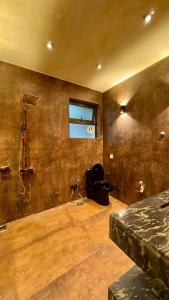 a room with a bed and a shower in it at Royal Serviced Cottages in Murree +75 photos