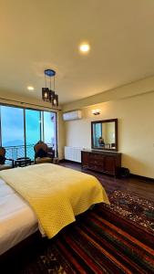 a bedroom with a large bed and a large mirror at Royal Serviced Cottages in Murree