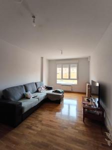 a living room with a couch and a television at Rincon Confort in Villamediana de Iregua