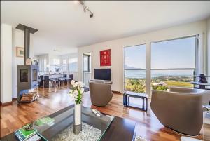 a living room with a view of the ocean at Panoramic Holiday Villa in Montreux in Montreux