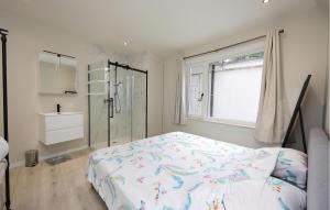 a bedroom with a bed and a glass shower at Amazing Apartment In Oostende With Wifi in Ostend