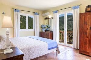 a bedroom with a bed and a large window at Villa Octavius in Ráchi +39 photos