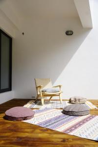 a living room with a chair and a rug at Yoyu Villa in Green Island