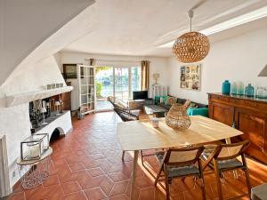 a living room with a wooden table and chairs at Maison de Pêcheur à Port Grimaud 2 in Grimaud
