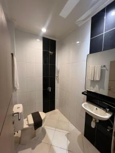 a bathroom with a toilet and a sink at Hotel Harmony in Batulicin +22 photos