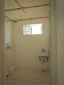 a bathroom with a sink and a window at Mama killa- Villa Stays in Pushkar