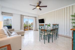 a living room with a table and chairs and a couch at Vilamoura Central 2 Bedroom Flat in Vilamoura