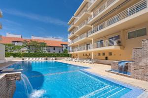 a swimming pool in front of a building at Vilamoura Central 2 Bedroom Flat in Vilamoura