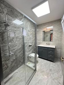 une salle de bain avec une douche, des toilettes et un lavabo dans l'établissement Villa Palm Foçaköy, à Foça