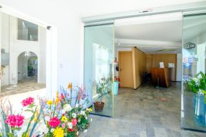 a lobby with a bunch of flowers on display at Pandream Hotel Apartments in Paphos +37 photos