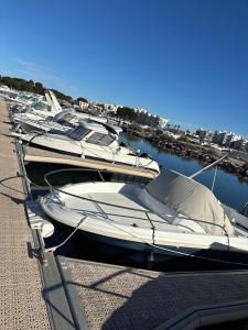 a row of boats are docked in a marina at Docked boat in Le Barcarès
