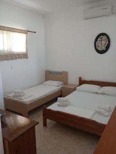 a room with two beds and a window at Kyriaki's Studio Aigina in Souvala