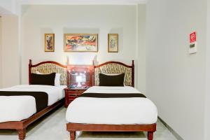 Uma cama ou camas num quarto em Palette Hotel And Resort Anand Formerly Hotel La Casa Inn
