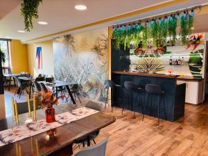 a restaurant with tables and chairs and a bar at Hotel Pohorje in Maribor