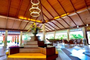 una hall con tavolo e vaso con fiori di Horizon Karon Beach Resort & Spa a Karon Beach