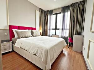 a bedroom with a large bed with a red headboard at HYDE3 i-City ITQAN Premium Home - 8pax, Netflix, Parking in Shah Alam +33 photos