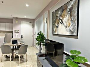a living room with a table and chairs and a laptop at HYDE3 i-City ITQAN Premium Home - 8pax, Netflix, Parking in Shah Alam