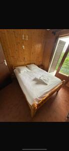 a large bed in a room with a window at Choucas in Thollon