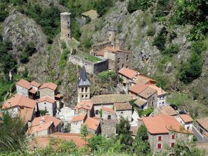 a small town on a hill with a castle at Au fil de l'eau - Nature in Saint-Floret