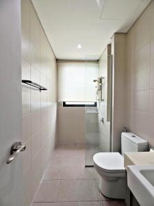 a bathroom with a toilet and a sink and a shower at HYDE3 i-City ITQAN Premium Home - 8pax, Netflix, Parking in Shah Alam