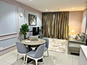a living room with a table and chairs and a couch at HYDE3 i-City ITQAN Premium Home - 8pax, Netflix, Parking in Shah Alam