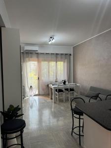 a living room with a table and chairs at Trilocale vicino al mare in Lido di Ostia
