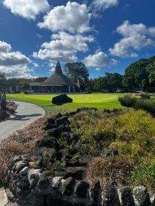 a view of a golf course with a building in the background at Mont Choisy Golf & Estate Suite in Grand Baie