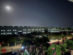 a view of a building at night at Room with garden view in Kamëz