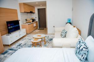 a living room with a white bed and a couch at Tulia Haven in Ruaka