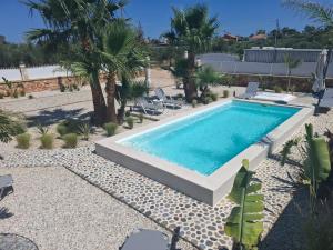a swimming pool in a resort with palm trees at Villa Dadis in Chania