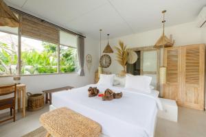 Postel nebo postele na pokoji v ubytování La Joya Balangan Resort + 37 fotografií