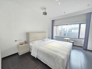 Voodi või voodid majutusasutuse Time Wharf Hotel - Jiefangbei Shibati Branch toas