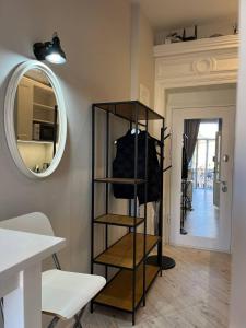 a black shelf in a room with a mirror at Lucky Apartmens in centre Lviv in Lviv