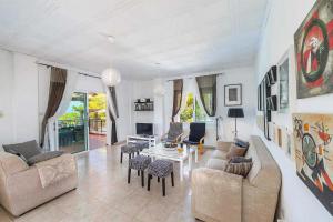 a living room with a couch and chairs and a table at Pine Retreat in Argaka