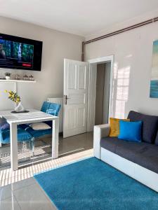 a living room with a white table and a couch at Apartment Laura in Senj