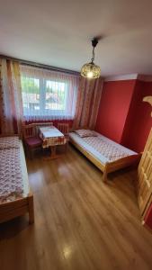 a room with two beds and a window at Noclegi u Danuty in Groń