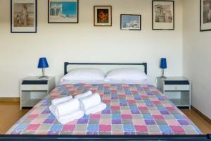 a bedroom with a large bed with towels on it at Frontemare - Casa Casoni in Marcelli