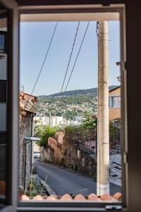 a view of a street from a window at Hurban Apartments La Casa dei Fiori in Trieste