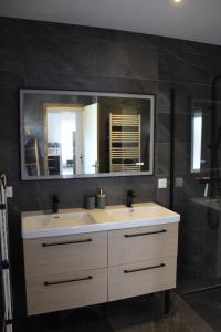 a bathroom with a sink and a mirror at Laetoile in Granges-sur-Vologne +22 photos