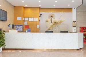 上海GreenTree Inn的大楼内带大型白色柜台的大堂
