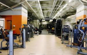 a gym with lots of treadmills and machines at Holiday Spa Luxury Suite w Sauna FREE Parking in Tampere