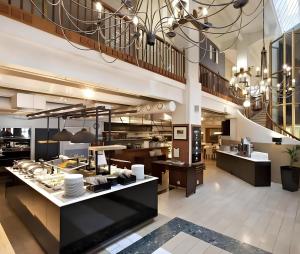 a large kitchen with a buffet in a building at Holiday Spa Luxury Suite w Sauna FREE Parking in Tampere