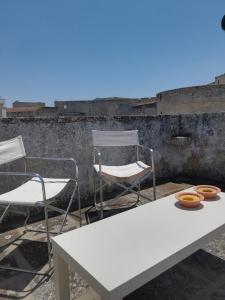 a table and two chairs and a white table and chairs at Vista Castello - Otranto in Otranto +23 photos