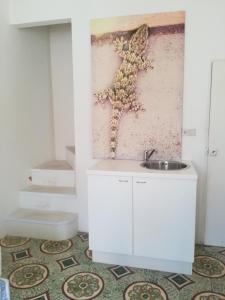 a bathroom with a sink and a wall at Vista Castello - Otranto in Otranto